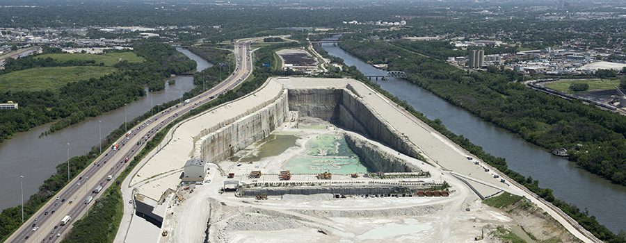 A large concrete wall with water coming out of it.