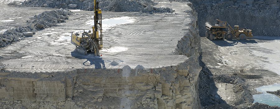 A large pile of rock is being worked on.