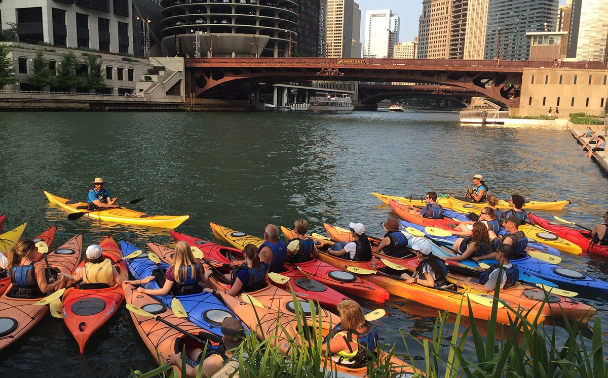 A group of people in kayaks on the water.