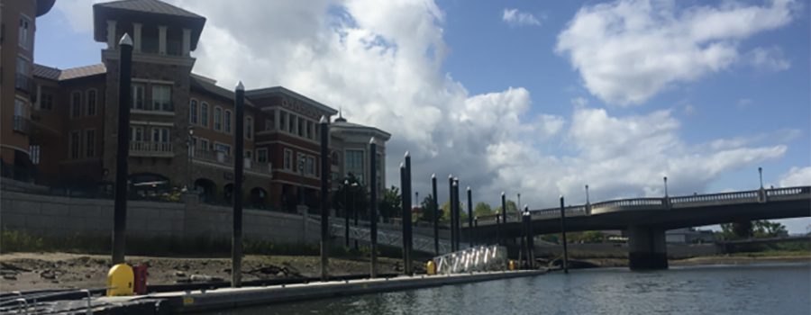 A dock with a large building in the background.